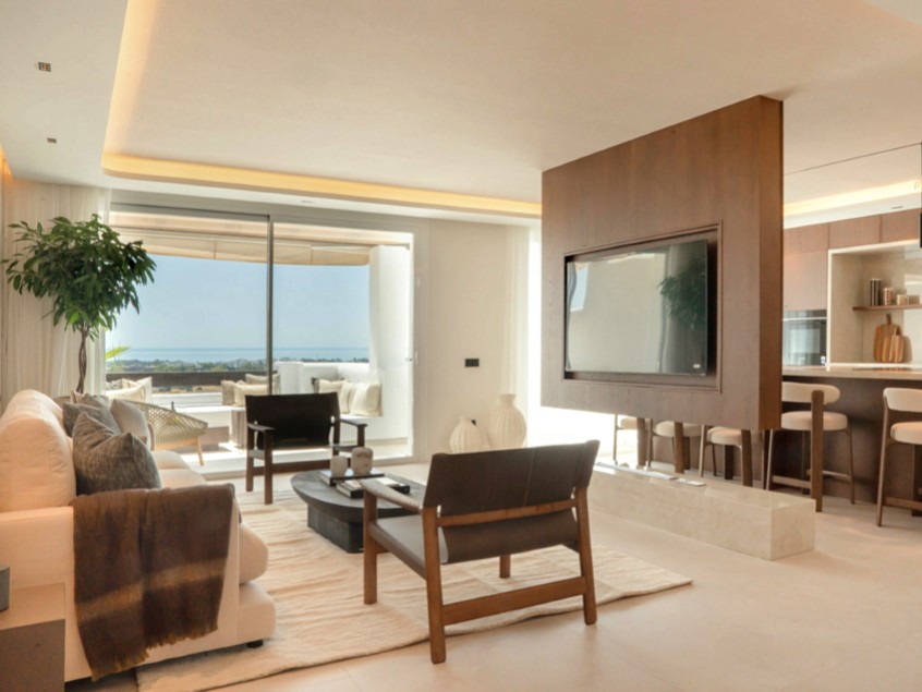 Living room with a partial divider to the open-concept kitchen