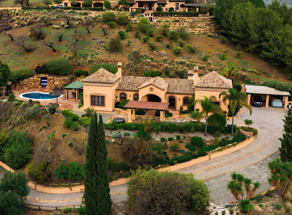 Country Villa in Monda with Mountain Views Exterior view of the Monda villa showing the terraces, pool area and hillside setting with wide countryside views.