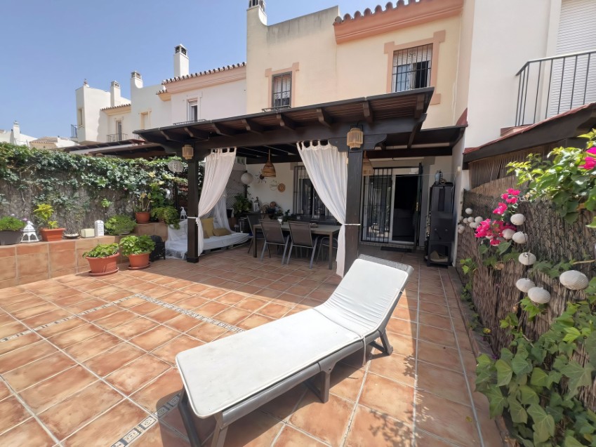 Townhouse in El Coto Mijas Costa Exterior view of a 3 bedroom townhouse in El Coto, Mijas Costa, within a gated community with gardens and pools.