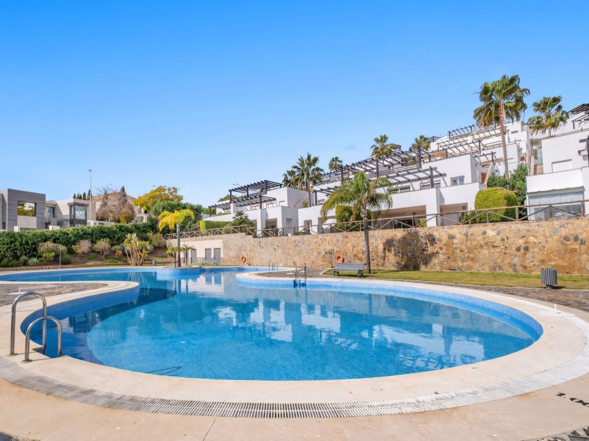 Exterior view of a townhouse in Santa Clara Golf Marbella with terraces and pool Santa Clara Golf Marbella townhouse