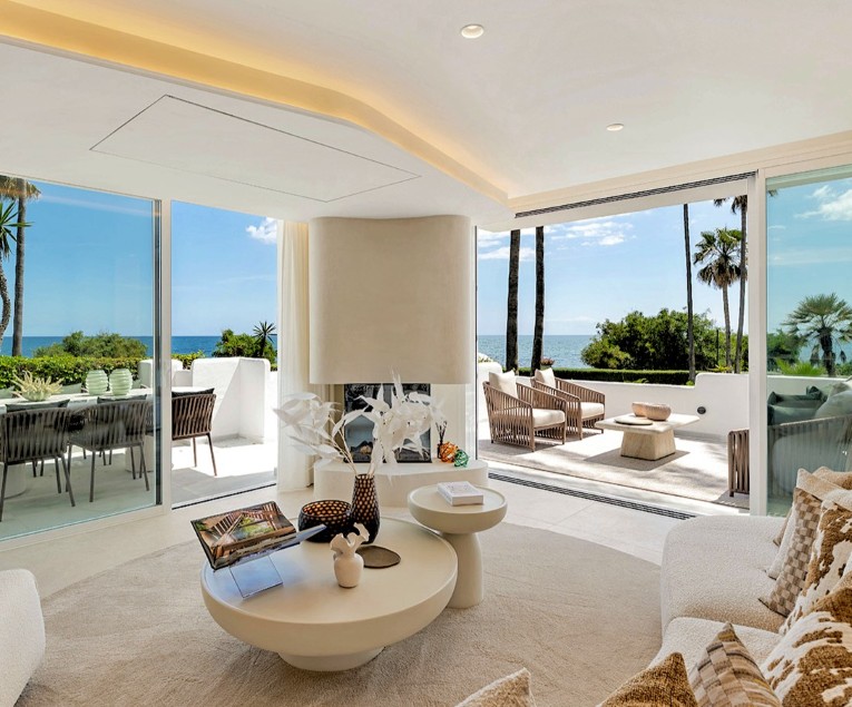Renovated front line beach apartment at Alcazaba Beach Estepona Open-plan living room in a fully renovated front line beach apartment at Alcazaba Beach on the New Golden Mile in Estepona, with modern furnishings, sea views and direct access to the terrace.