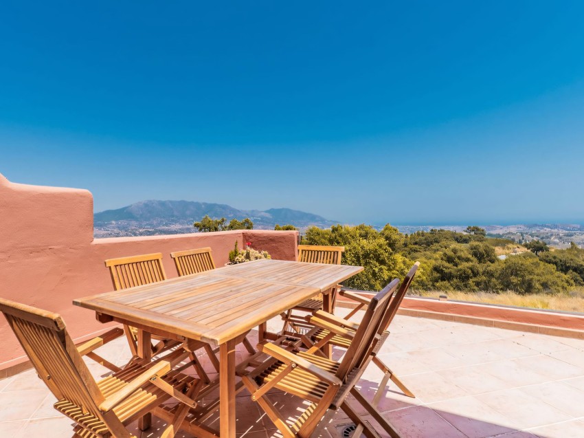 Vistas desde la terraza en Las Buganvillas, La Mairena Amplia terraza con vistas panorámicas sobre las colinas y la costa — una característica destacada de este espacioso apartamento en La Mairena.